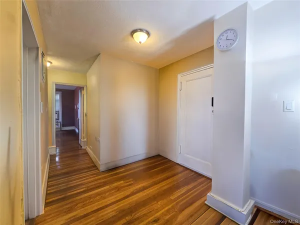 a view of a room with wooden floor