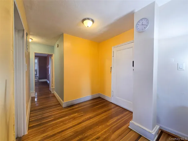 a view of a room with wooden floor
