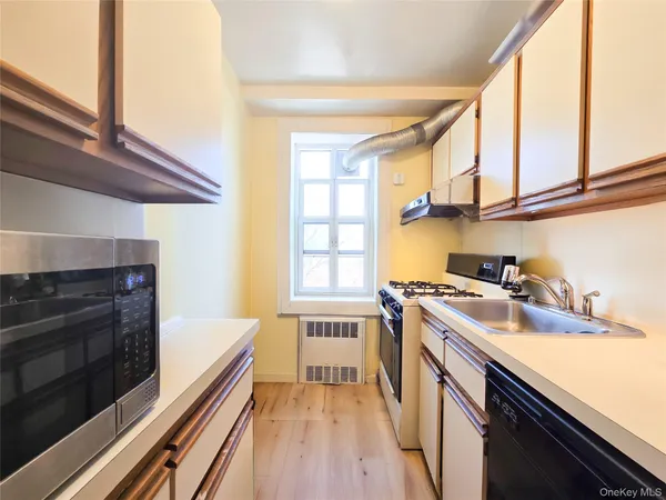 a kitchen with a stove a sink and a microwave