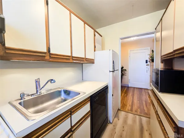a kitchen with stainless steel appliances granite countertop a sink and a refrigerator