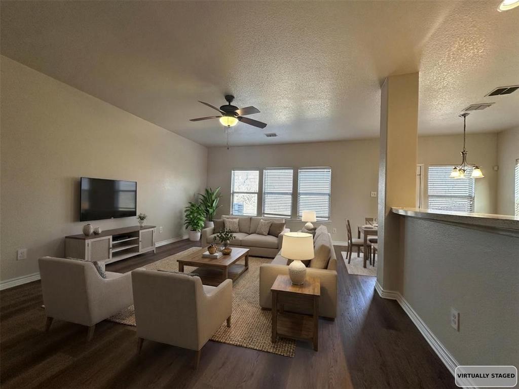 6549 Compass Ridge Drive Dallas, TX 75249 - Photo 6 of 19 a living room with furniture a flat screen tv and a window