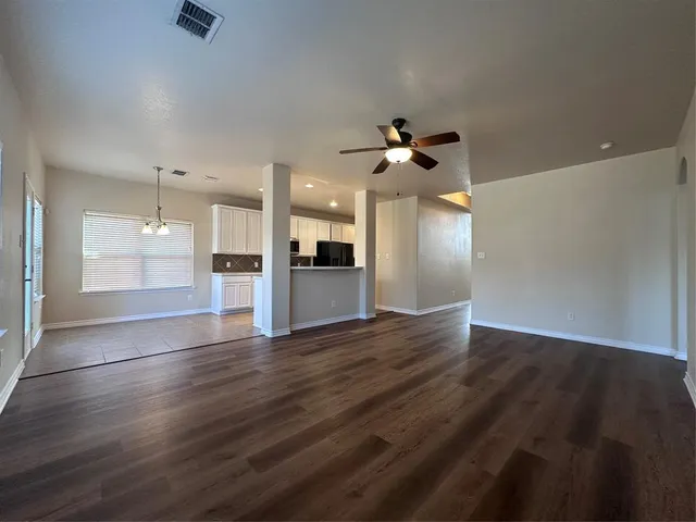 a view of an empty room with a kitchen
