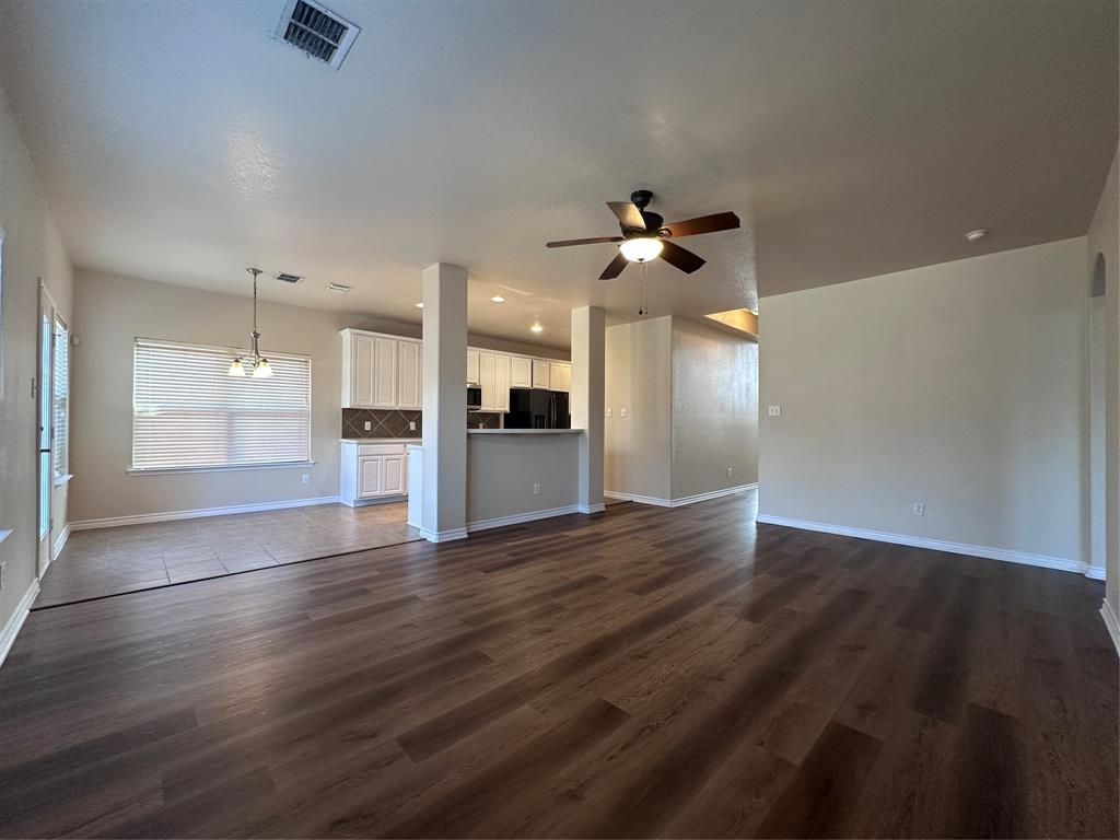 6549 Compass Ridge Drive Dallas, TX 75249 - Photo 7 of 19 a view of an empty room with a kitchen