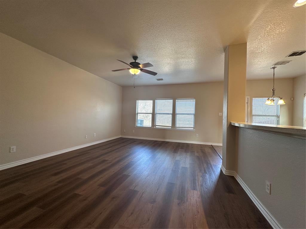 6549 Compass Ridge Drive Dallas, TX 75249 - Photo 10 of 19 an empty room with wooden floor and windows