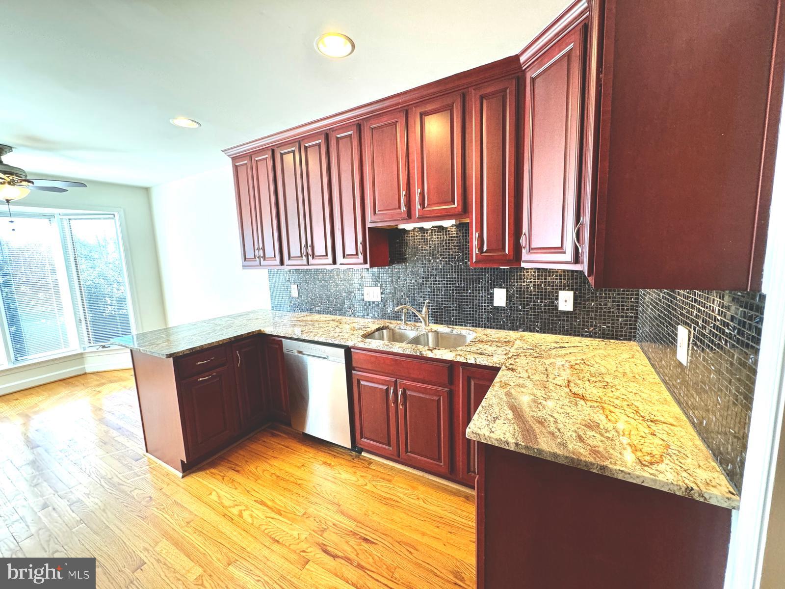 1447 Hampton Hill Circle McLean, VA 22101 - Photo 15 of 46 a kitchen with a sink and a wooden cabinets