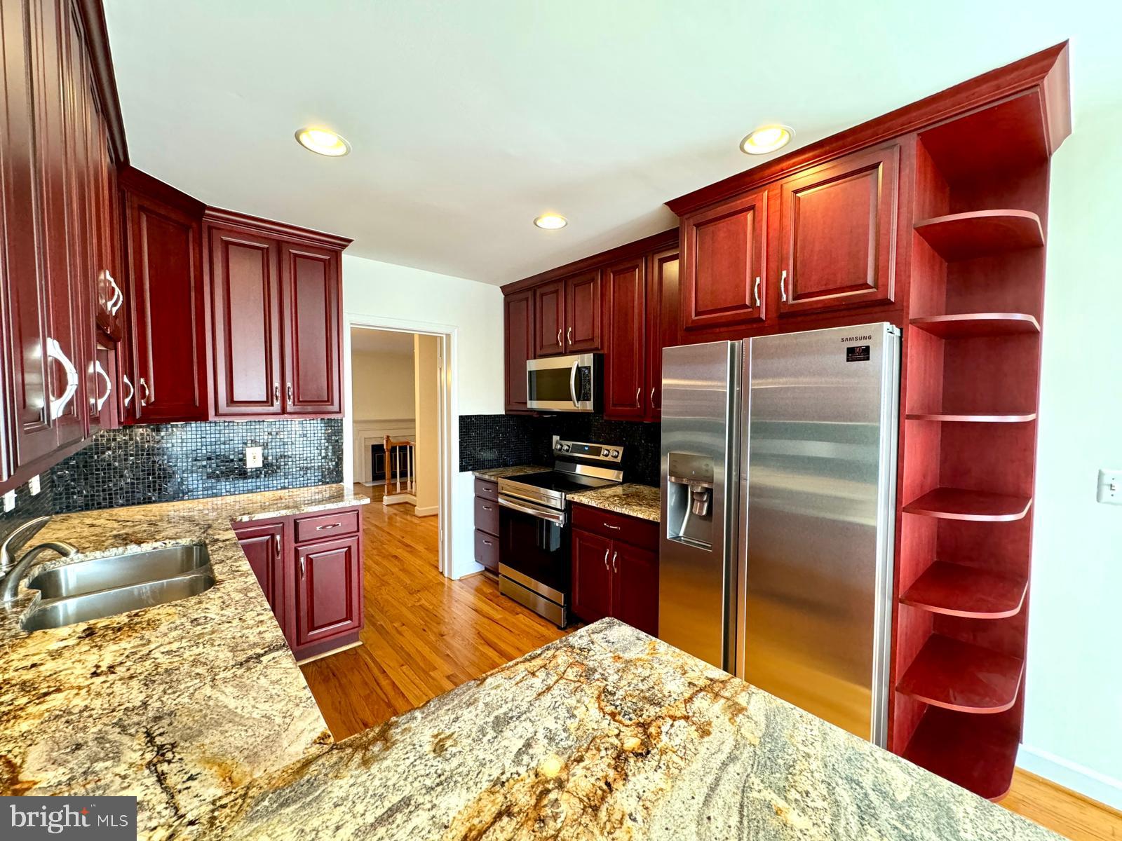 1447 Hampton Hill Circle McLean, VA 22101 - Photo 16 of 46 a kitchen with stainless steel appliances granite countertop a refrigerator a stove top oven and cabinets