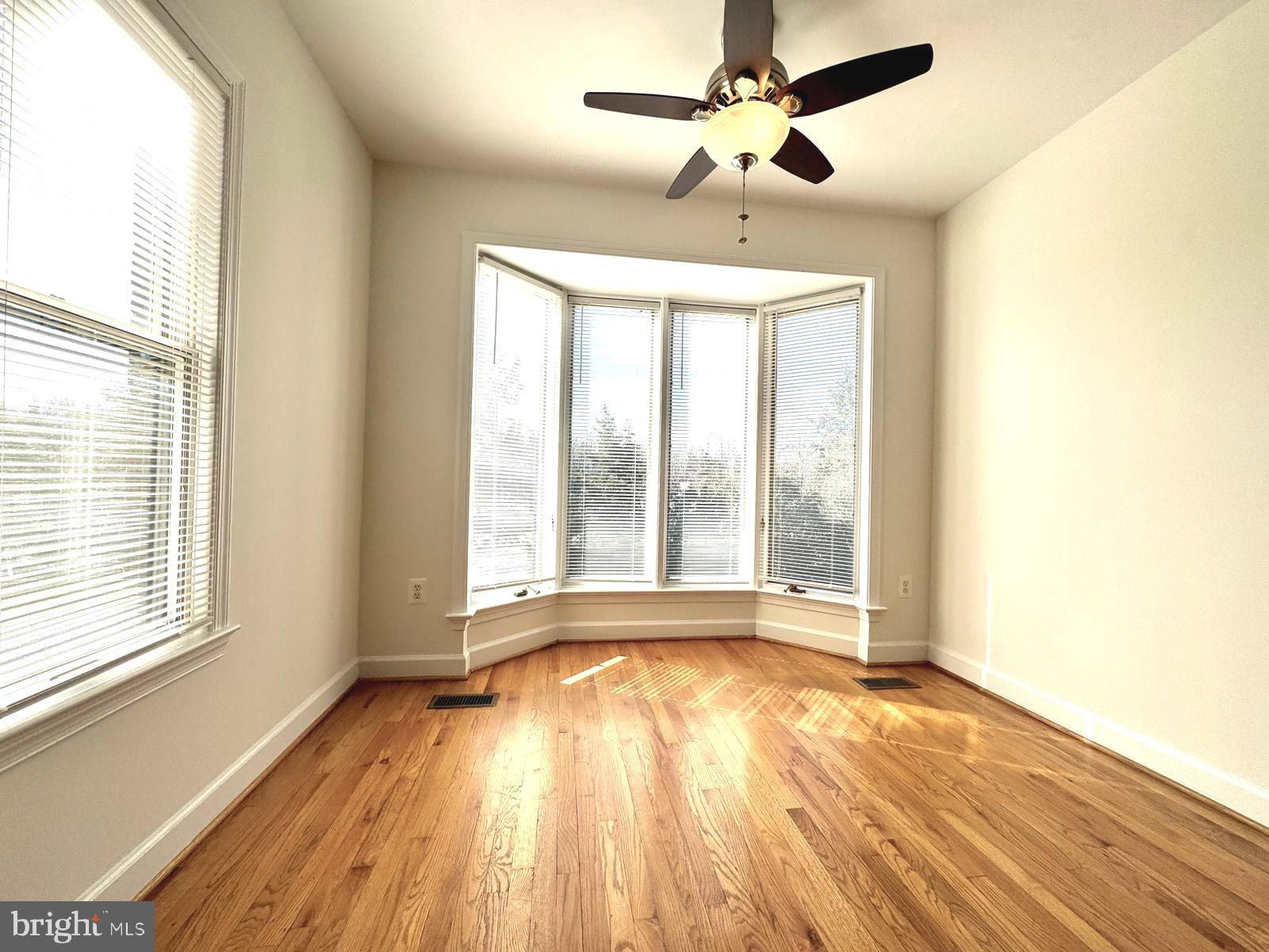 1447 Hampton Hill Circle McLean, VA 22101 - Photo 18 of 46 a view of an empty room with wooden floor and a window