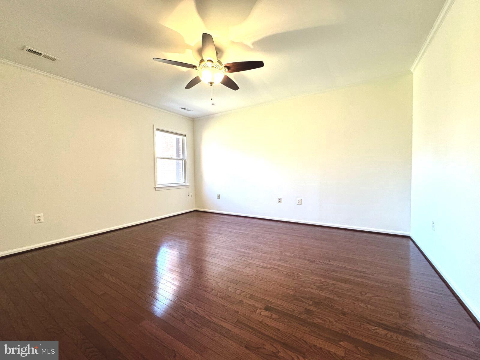 1447 Hampton Hill Circle McLean, VA 22101 - Photo 19 of 46 an empty room with wooden floor fan and windows