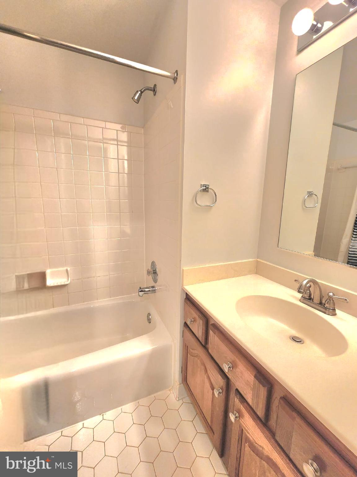 1447 Hampton Hill Circle McLean, VA 22101 - Photo 40 of 46 a bathroom with a granite countertop sink and a bathtub