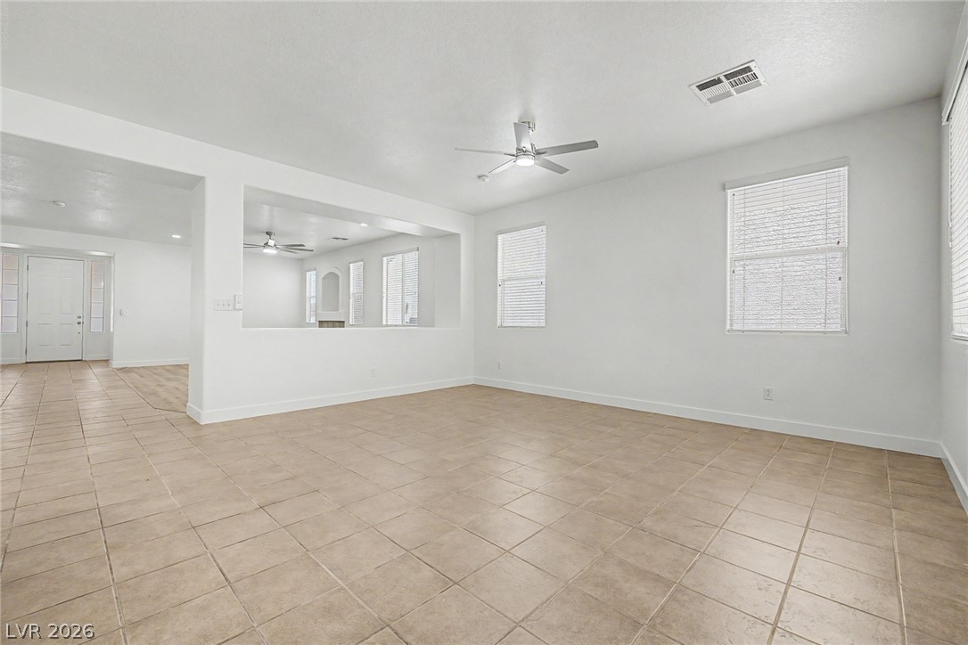 835 Entrada Ridge Avenue Henderson, NV 89012 - Photo 7 of 34 Well-lit living area showcases an open-concept layout and elegant tile flooring.