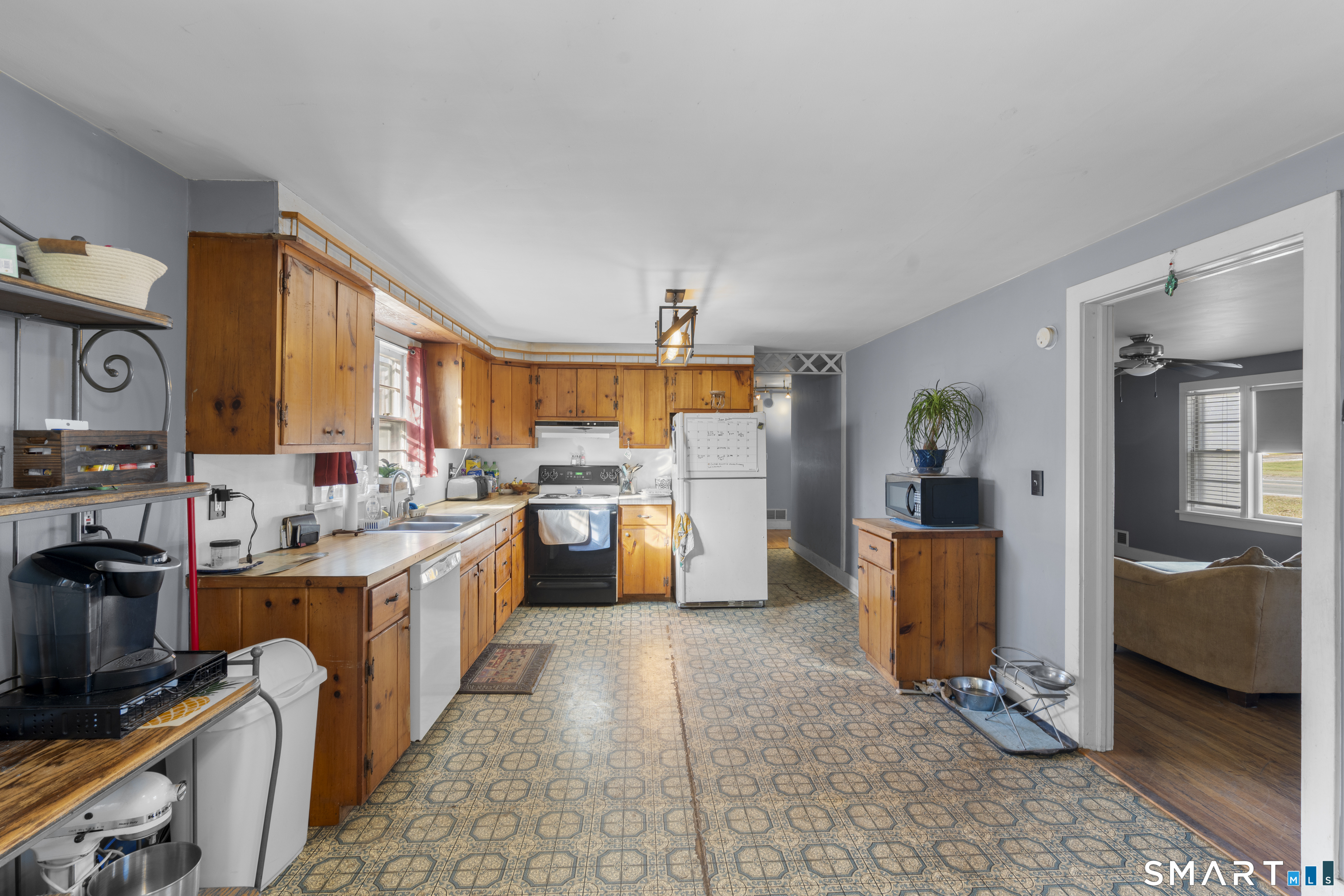 24 East Main Street North Canaan, CT 06018 - Photo 2 of 31 a large white kitchen with a stove a sink and a refrigerator