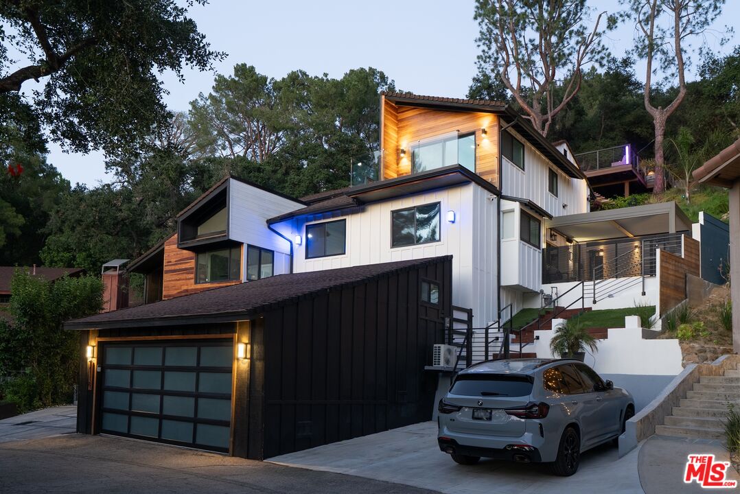 4118 Oak Hollow Road Calabasas, CA 91302 - Photo 3 of 55 a car parked in front of a white house