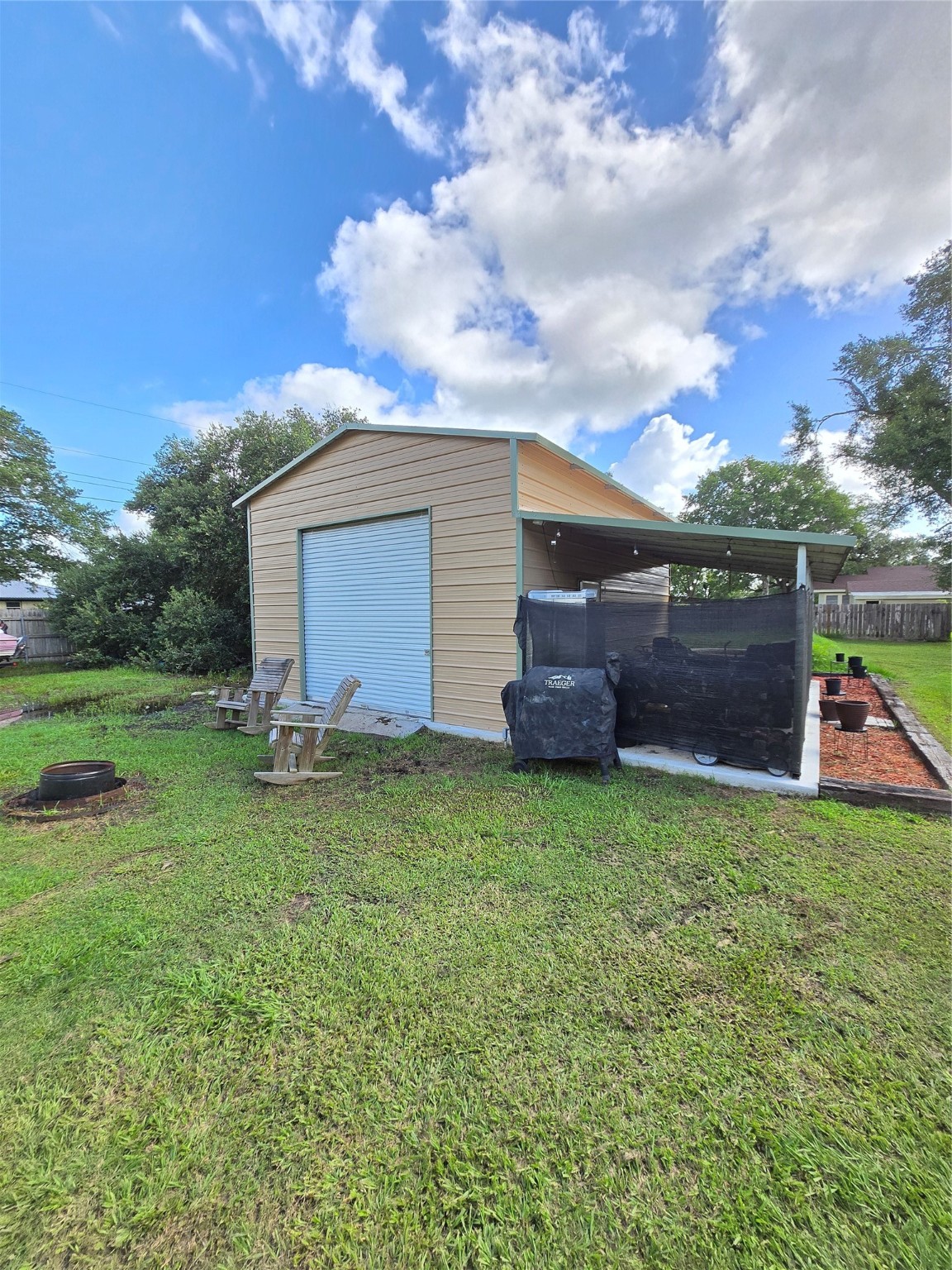 610 East Division Street Edna, TX 77957 - Photo 11 of 38 a view of a backyard with potted plants and large tree