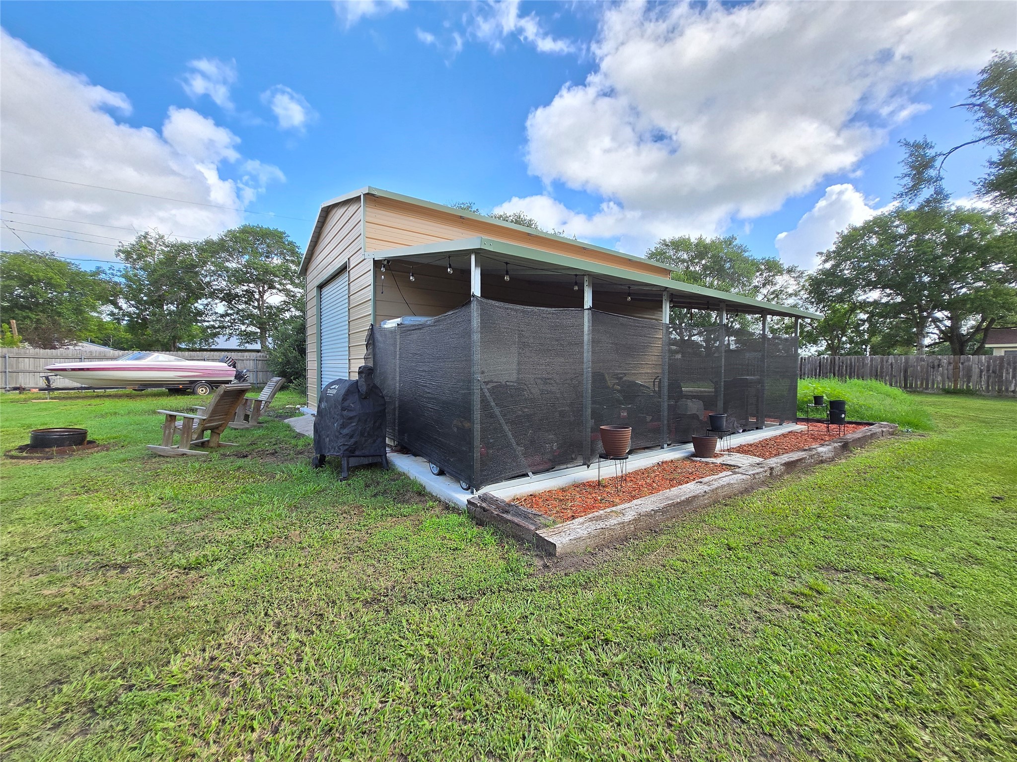 610 East Division Street Edna, TX 77957 - Photo 13 of 38 a view of a backyard with a garden and entertaining space