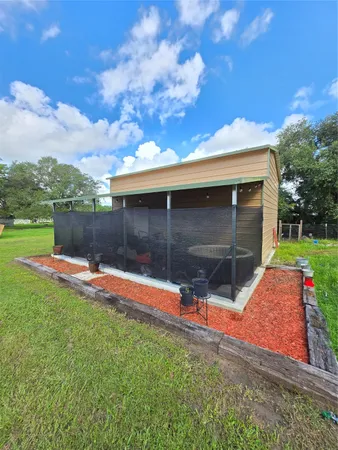 a view of backyard with wooden fence