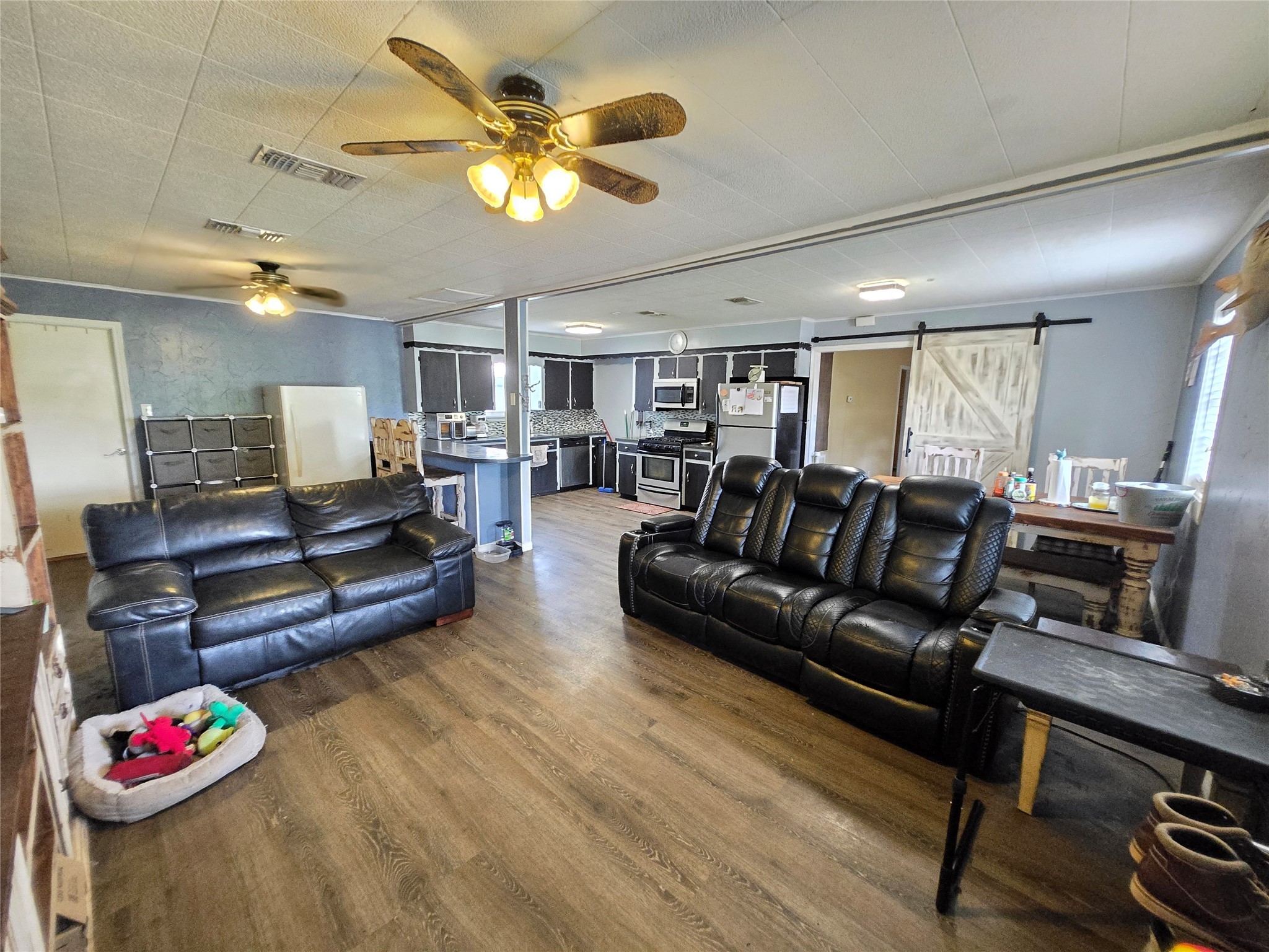 610 East Division Street Edna, TX 77957 - Photo 17 of 38 a living room with furniture kitchen view and a wooden floor