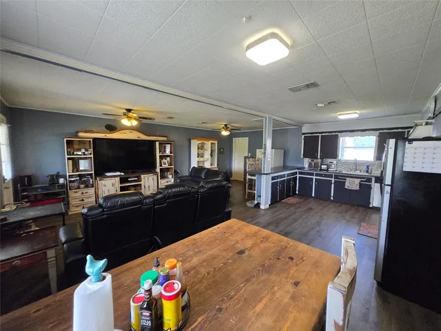a large kitchen with a table and chairs