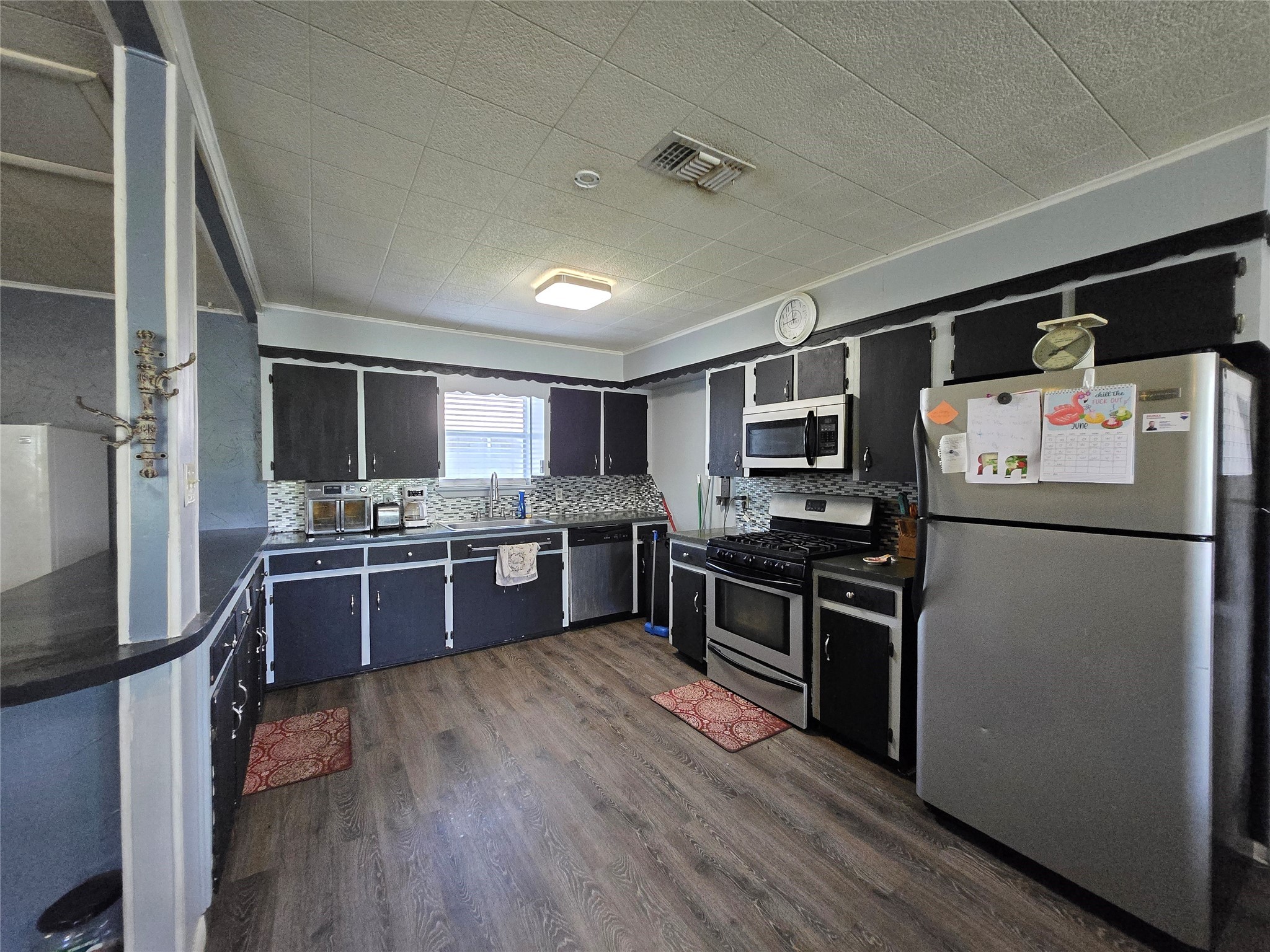 610 East Division Street Edna, TX 77957 - Photo 23 of 38 a kitchen with stainless steel appliances kitchen island granite countertop a refrigerator stove and sink