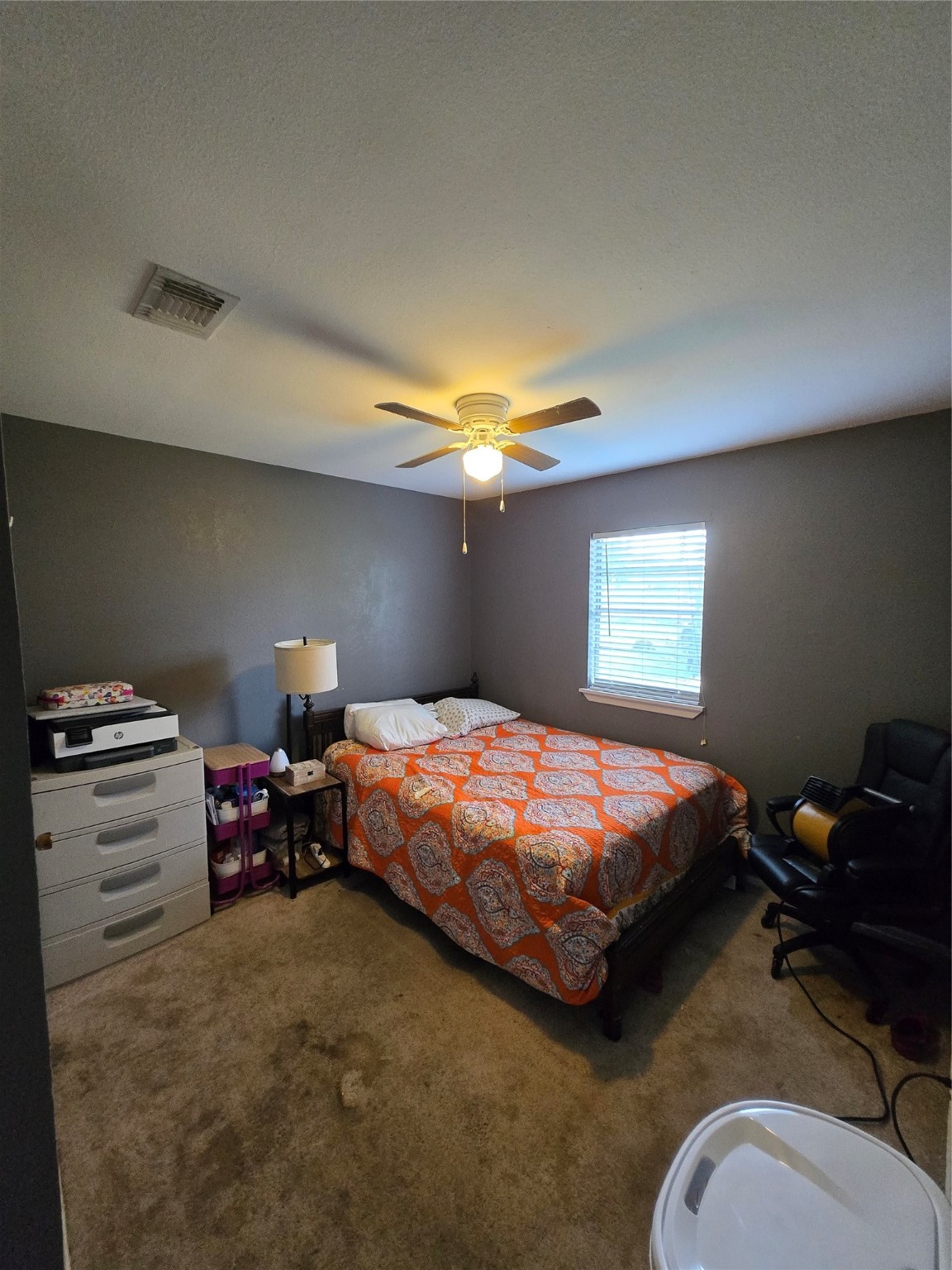 610 East Division Street Edna, TX 77957 - Photo 26 of 38 a bedroom with a bed and a chandelier