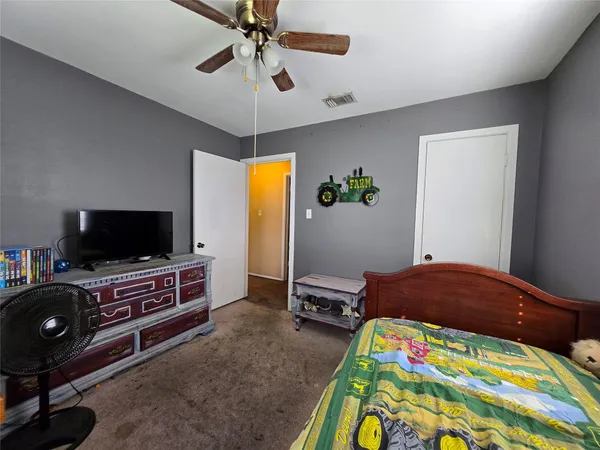 a bedroom with a bed and flat screen tv