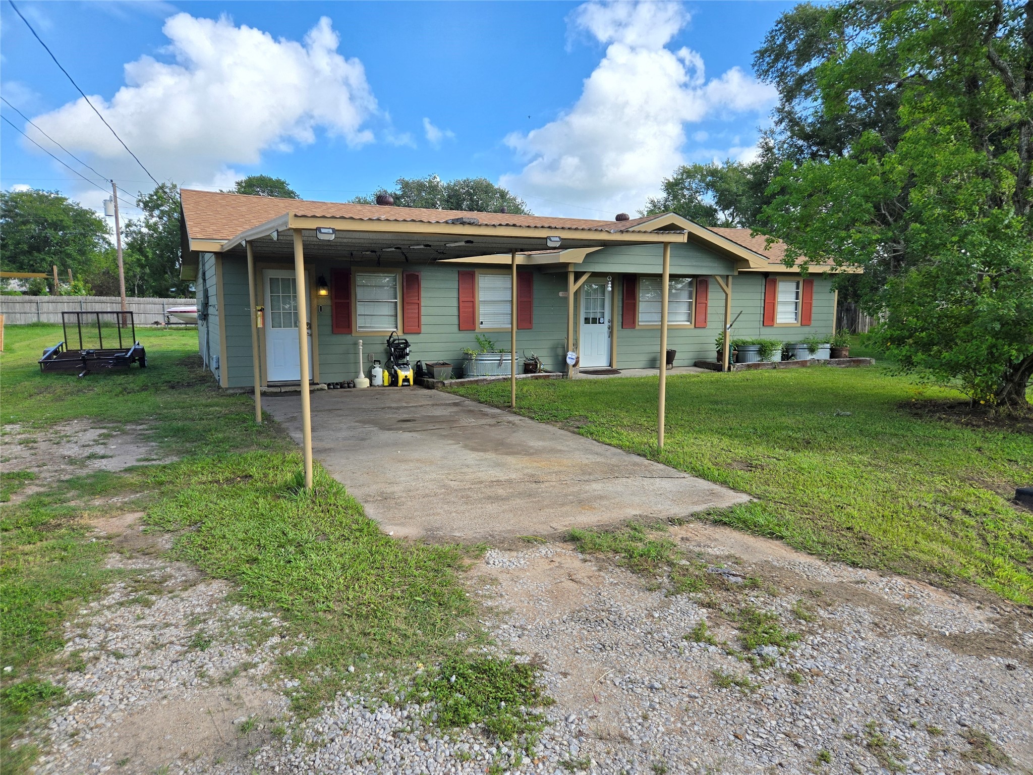 610 East Division Street Edna, TX 77957 - Photo 3 of 38 a front view of a house with a yard and porch