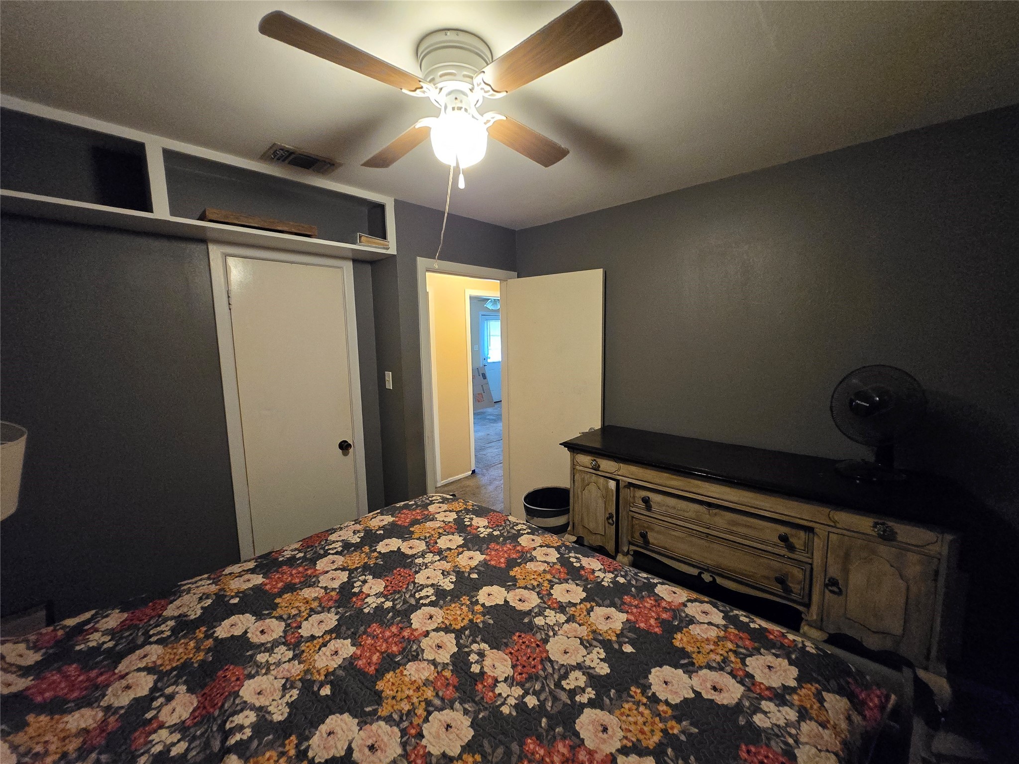 610 East Division Street Edna, TX 77957 - Photo 32 of 38 a bedroom with a bed and a chandelier