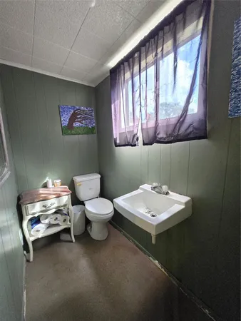 a bathroom with a toilet sink and mirror