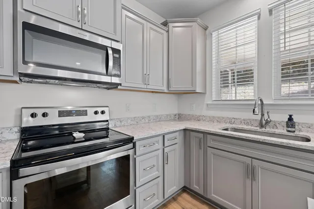 a stove top oven sitting inside of a kitchen