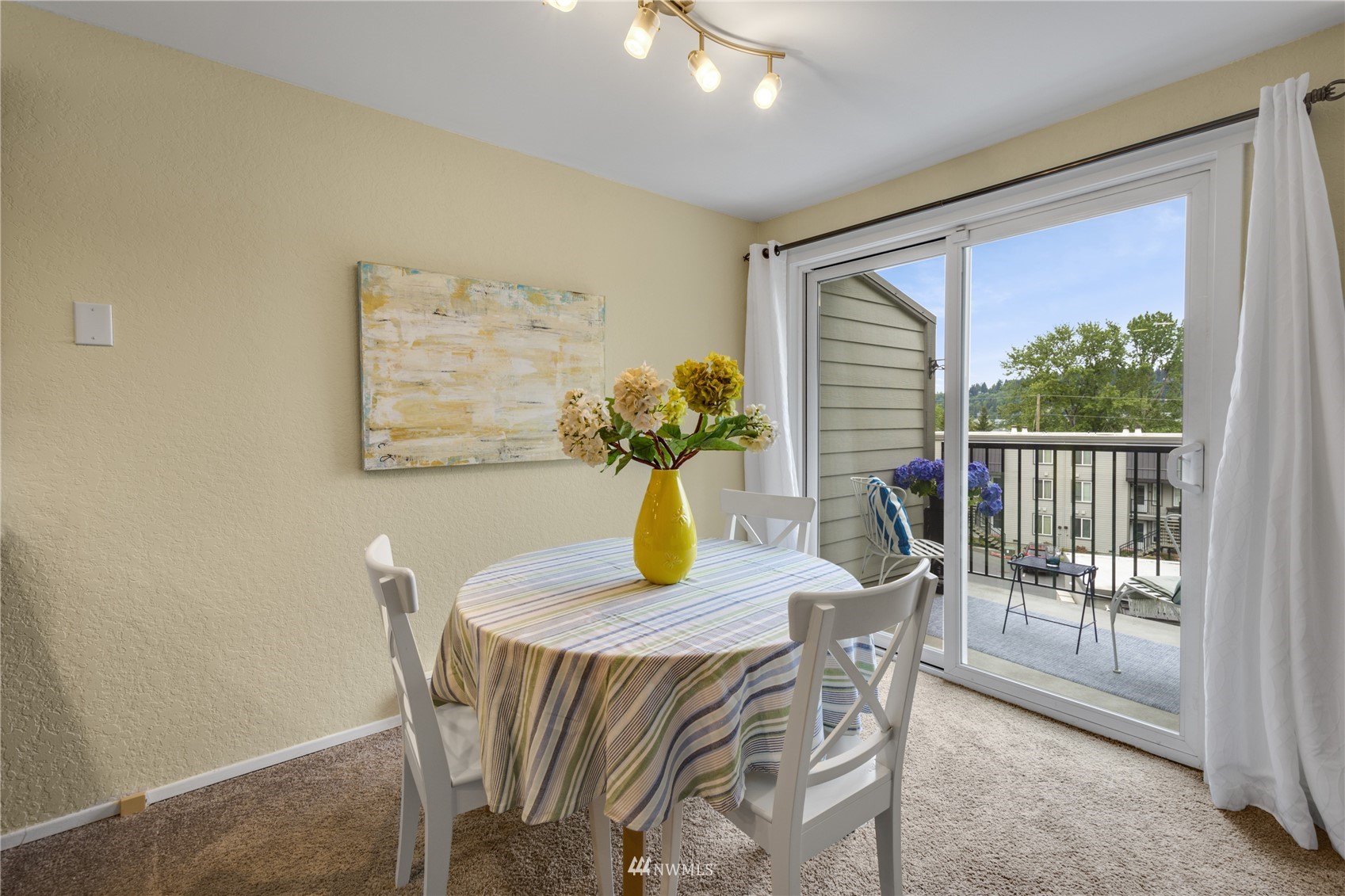 4100 Lake Washington Boulevard North, Unit D203 Renton, WA 98056 - Photo 14 of 30 a view of a dining room with furniture and a potted plant