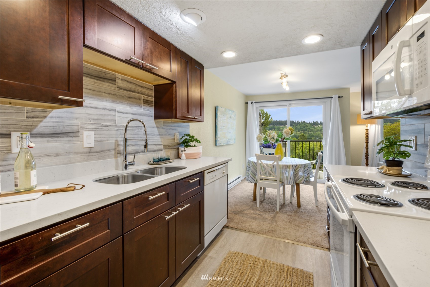 4100 Lake Washington Boulevard North, Unit D203 Renton, WA 98056 - Photo 15 of 30 a kitchen with a sink stove and cabinets