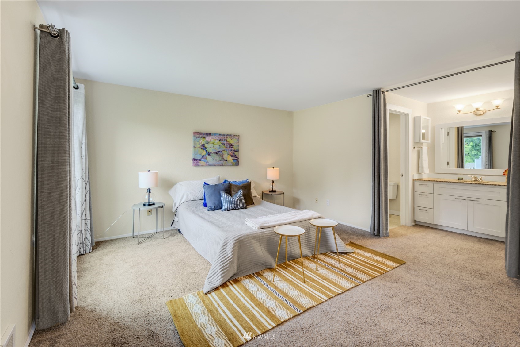 4100 Lake Washington Boulevard North, Unit D203 Renton, WA 98056 - Photo 18 of 30 a bedroom with a bed and a chandelier