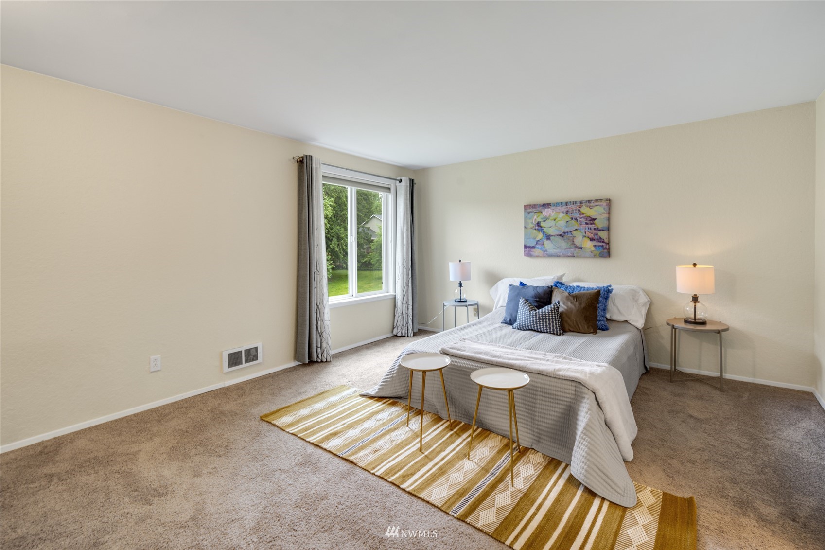 4100 Lake Washington Boulevard North, Unit D203 Renton, WA 98056 - Photo 19 of 30 a bedroom with a bed and wooden floor