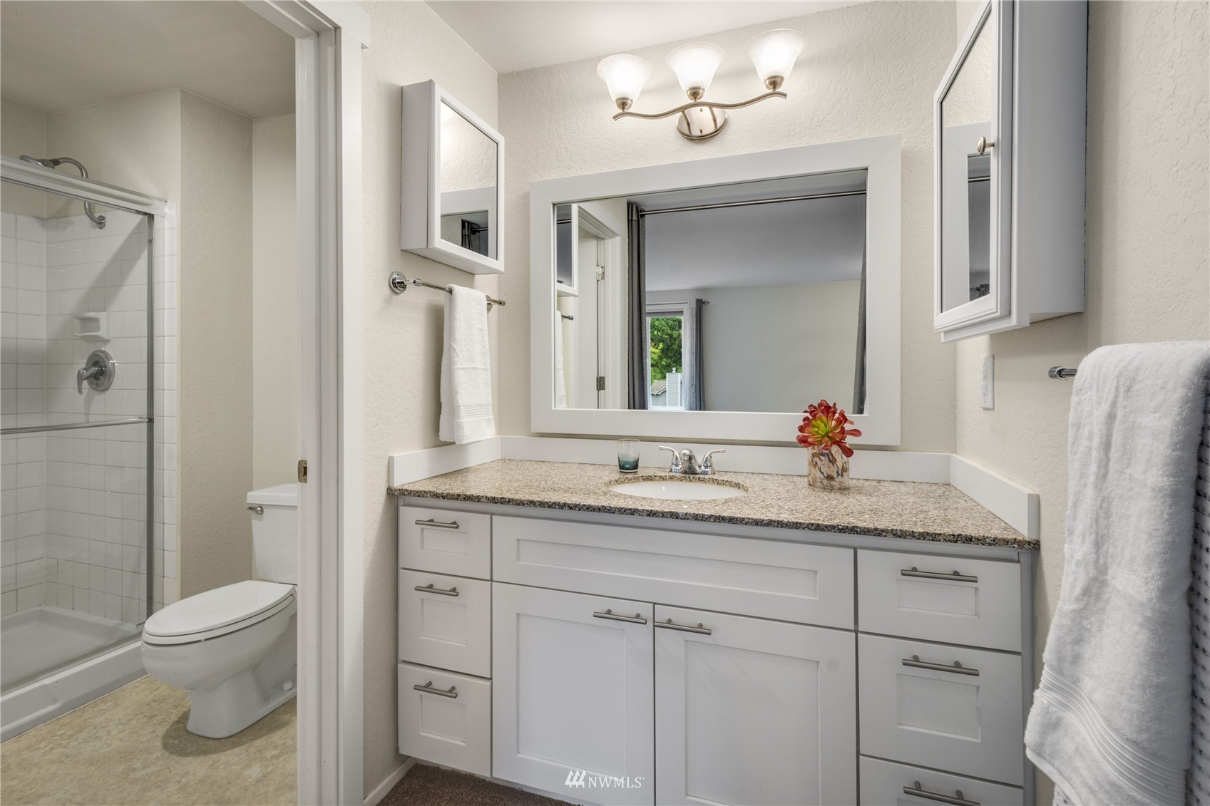 4100 Lake Washington Boulevard North, Unit D203 Renton, WA 98056 - Photo 21 of 30 a bathroom with a granite countertop sink toilet and shower