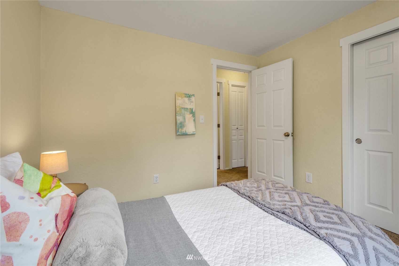 4100 Lake Washington Boulevard North, Unit D203 Renton, WA 98056 - Photo 23 of 30 a bedroom with a bed dresser and a window