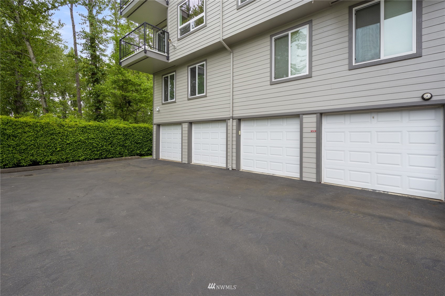 4100 Lake Washington Boulevard North, Unit D203 Renton, WA 98056 - Photo 26 of 30 a view of a house with a yard and garage