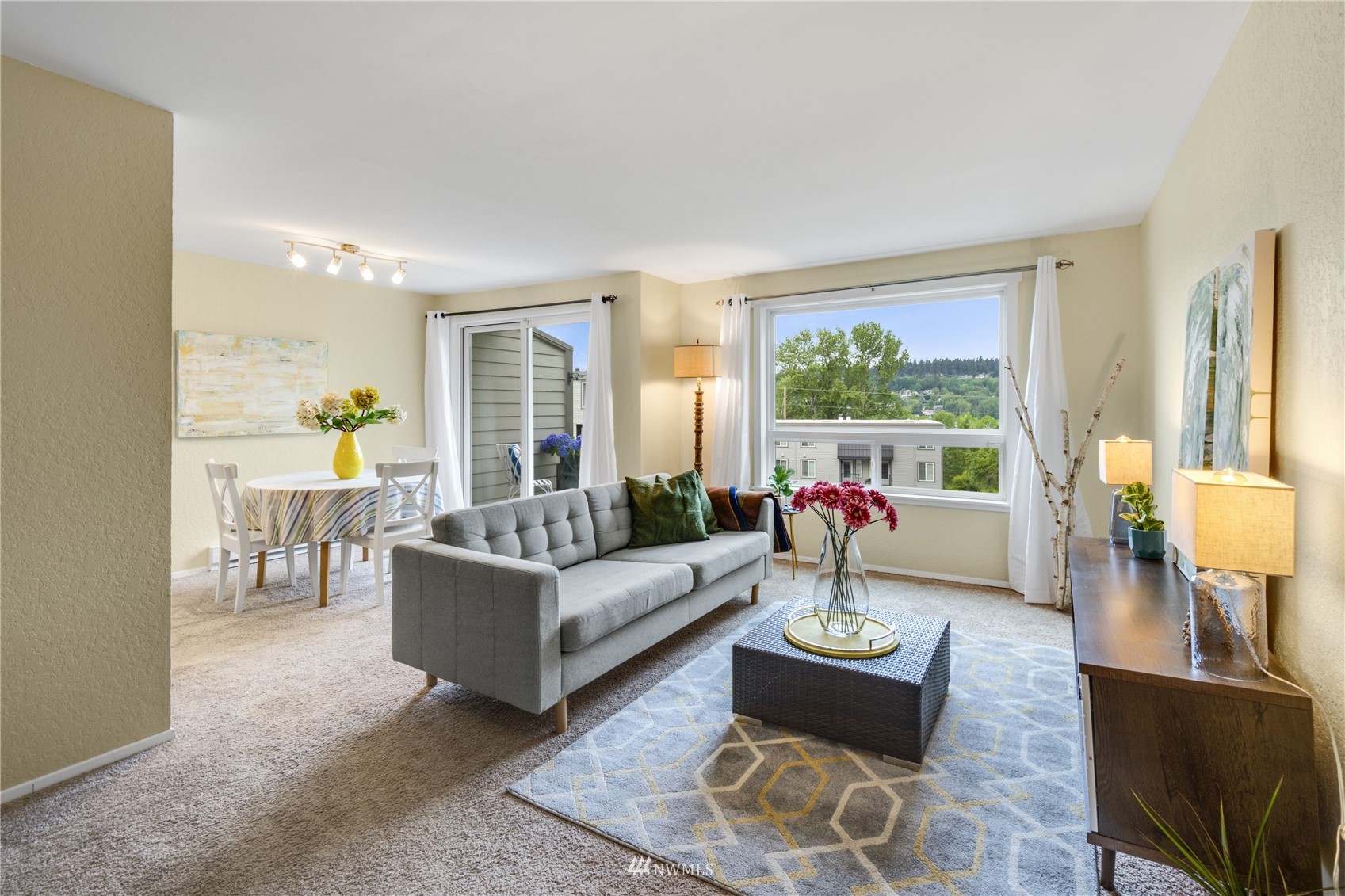 4100 Lake Washington Boulevard North, Unit D203 Renton, WA 98056 - Photo 9 of 30 a living room with furniture and a large window