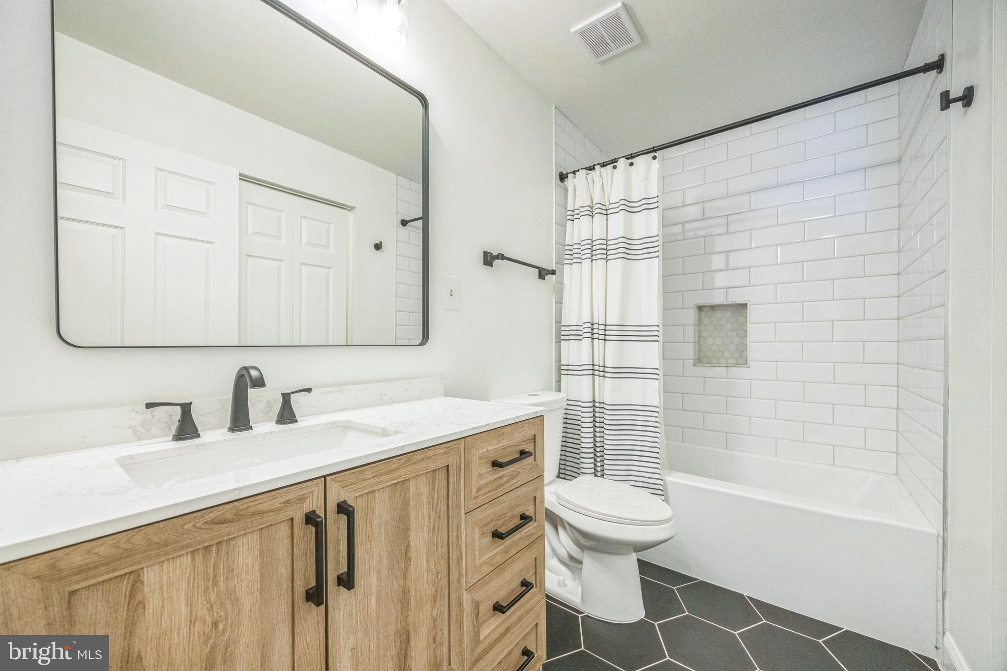 180 Tavistock Road Cherry Hill, NJ 08034 - Photo 12 of 15 a bathroom with a sink toilet a mirror and shower