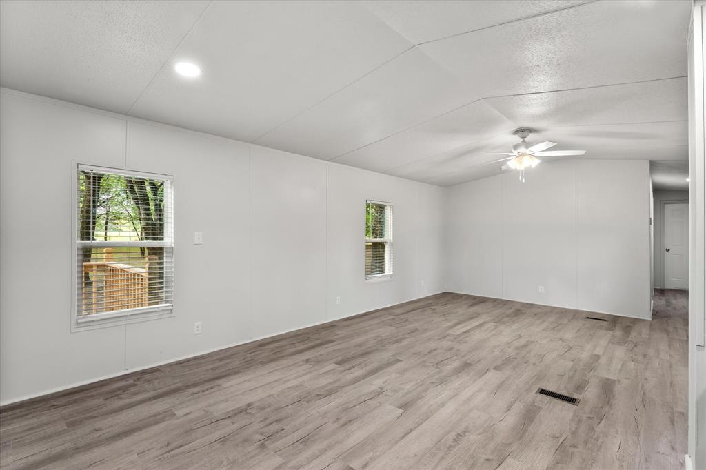 367 Box Road Gun Barrel City, TX 75156 - Photo 11 of 25 an empty room with wooden floor and windows