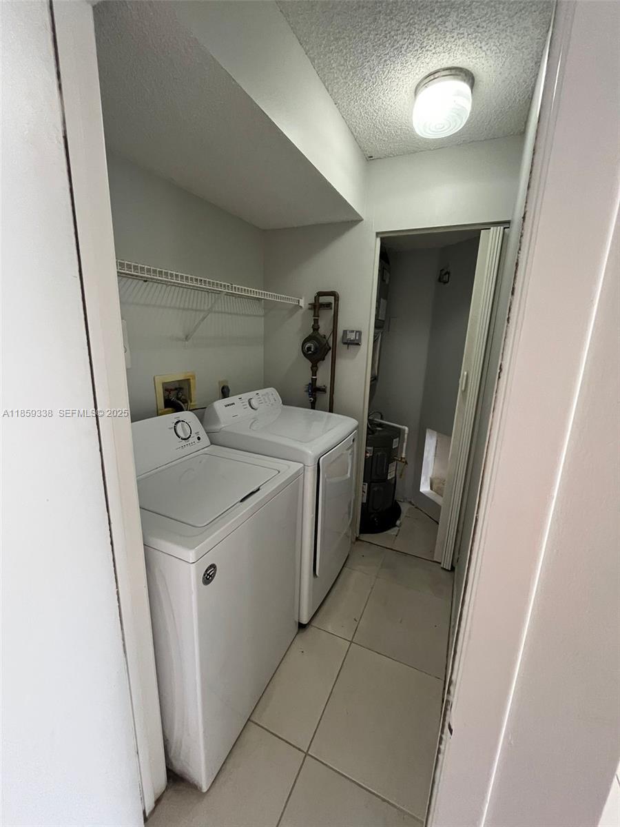 8821 Wiles Road, Unit 203 Coral Springs, FL 33067 - Photo 13 of 30 a utility room with dryer and washer