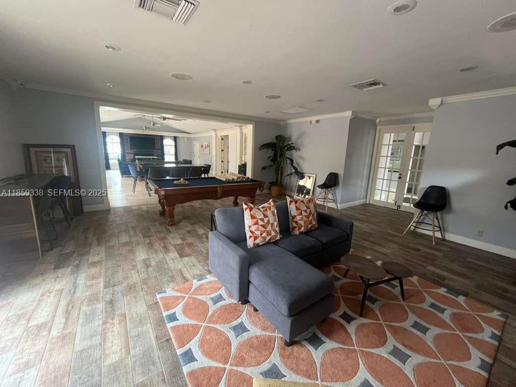 8821 Wiles Road, Unit 203 Coral Springs, FL 33067 - Photo 29 of 30 a living room with furniture and a rug