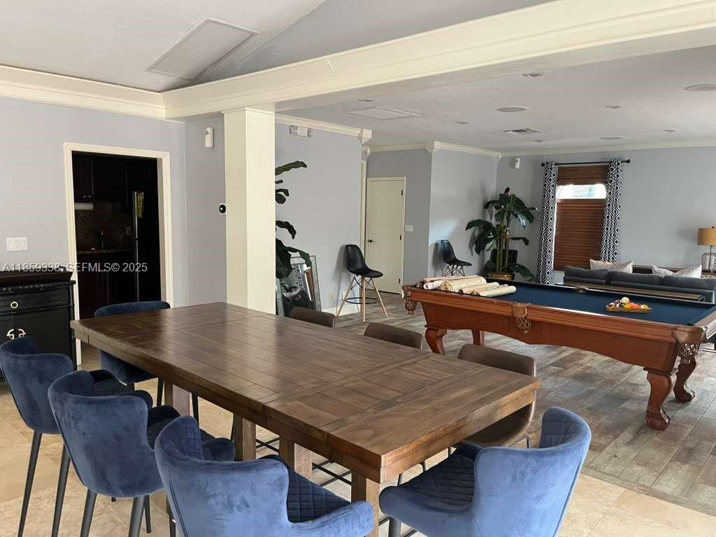 8821 Wiles Road, Unit 203 Coral Springs, FL 33067 - Photo 30 of 30 a dining room with wooden floor and tables