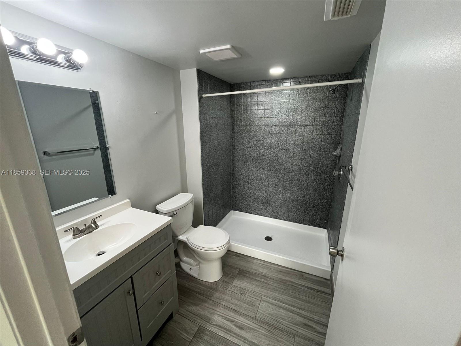 8821 Wiles Road, Unit 203 Coral Springs, FL 33067 - Photo 10 of 30 a bathroom with a sink a toilet and shower