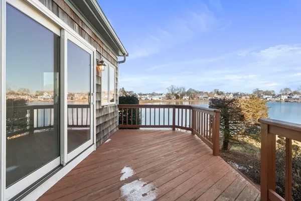 a view of a roof deck with wooden floor and city view
