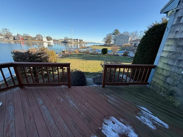 a view of a roof deck with wooden floor and city view