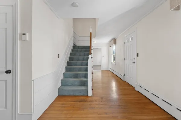 a view of an entryway with wooden floor