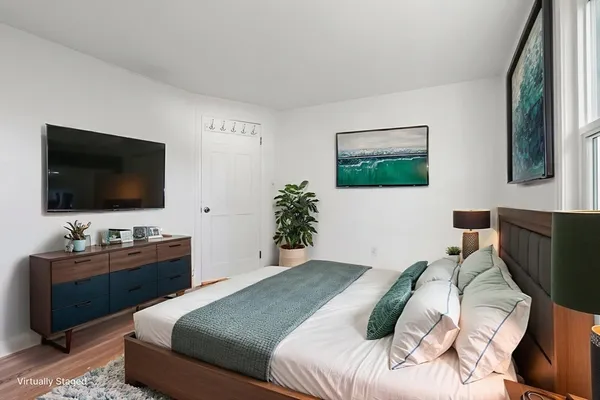 a bedroom with a bed and a flat screen tv