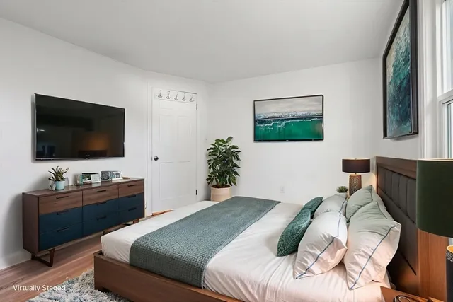 a bedroom with a bed and a flat screen tv