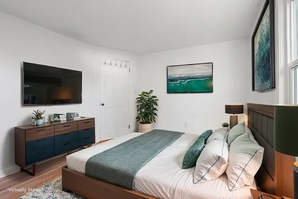 a bedroom with a large bed and a window