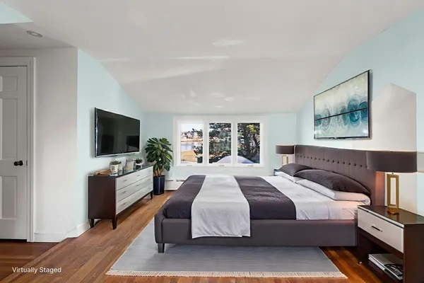 a bed room with a bed window and a chair