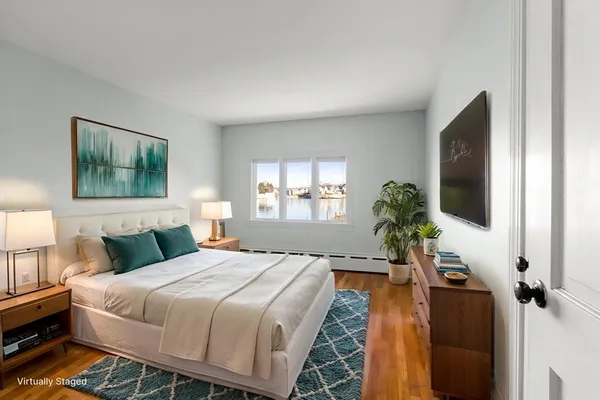 a bedroom with a bed and a flat screen tv